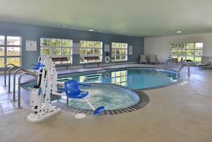 Una piscina techada, sillones reclinables de piscina