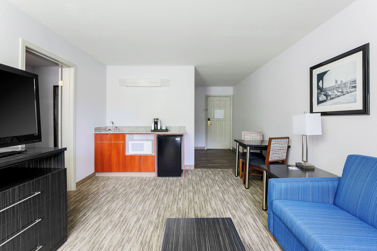 Premium bedding, desk, laptop workspace, blackout drapes