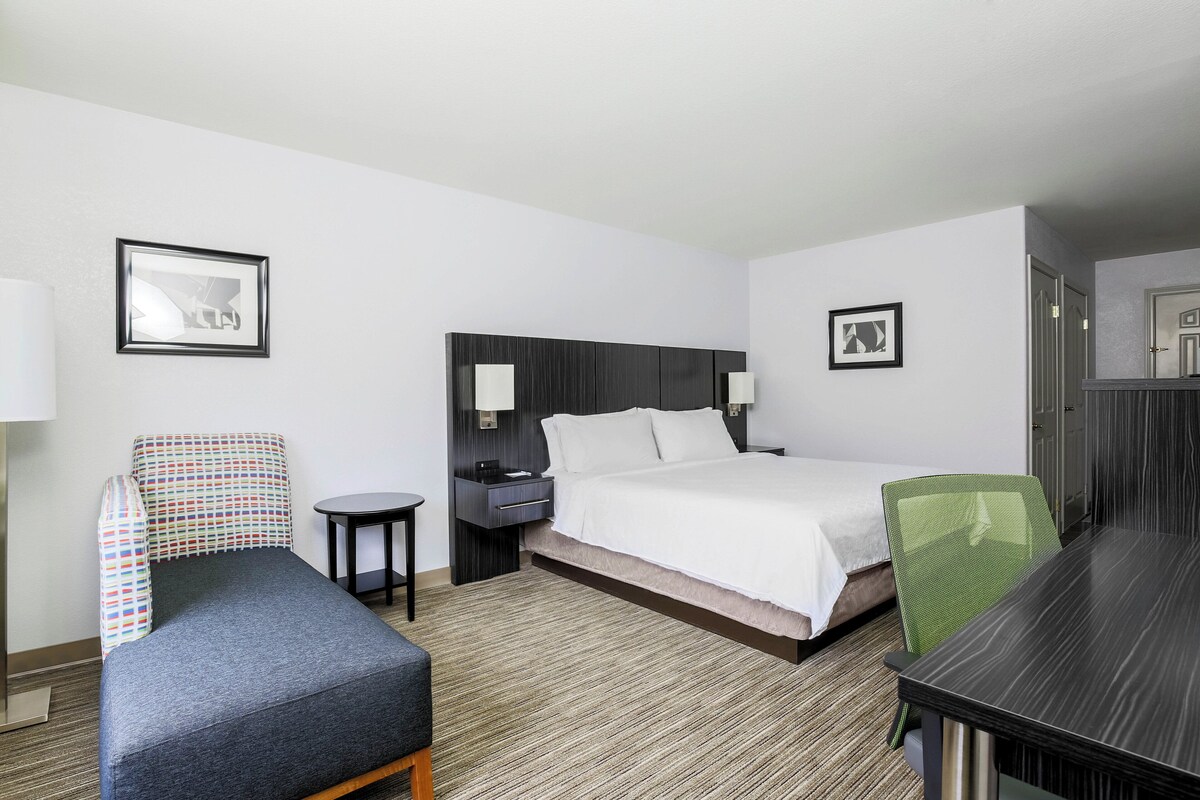 Premium bedding, desk, laptop workspace, blackout drapes