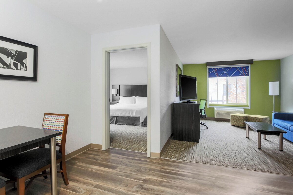 Premium bedding, desk, laptop workspace, blackout drapes