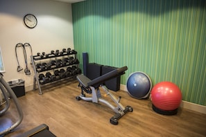 A gym with a bench, dumbbells, exercise balls, and a treadmill. - Holiday Inn Express Hotel & Suites Lexington-Downtown by IHG (Lexington)
