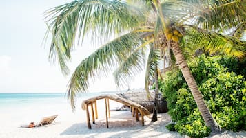 On the beach, white sand, free beach cabanas, sun loungers