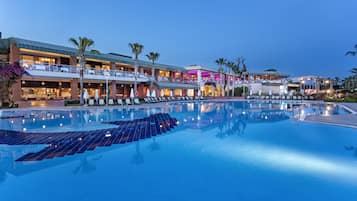 Enjoy a refreshing swim in our pool surrounded by lush gardens and palm trees.