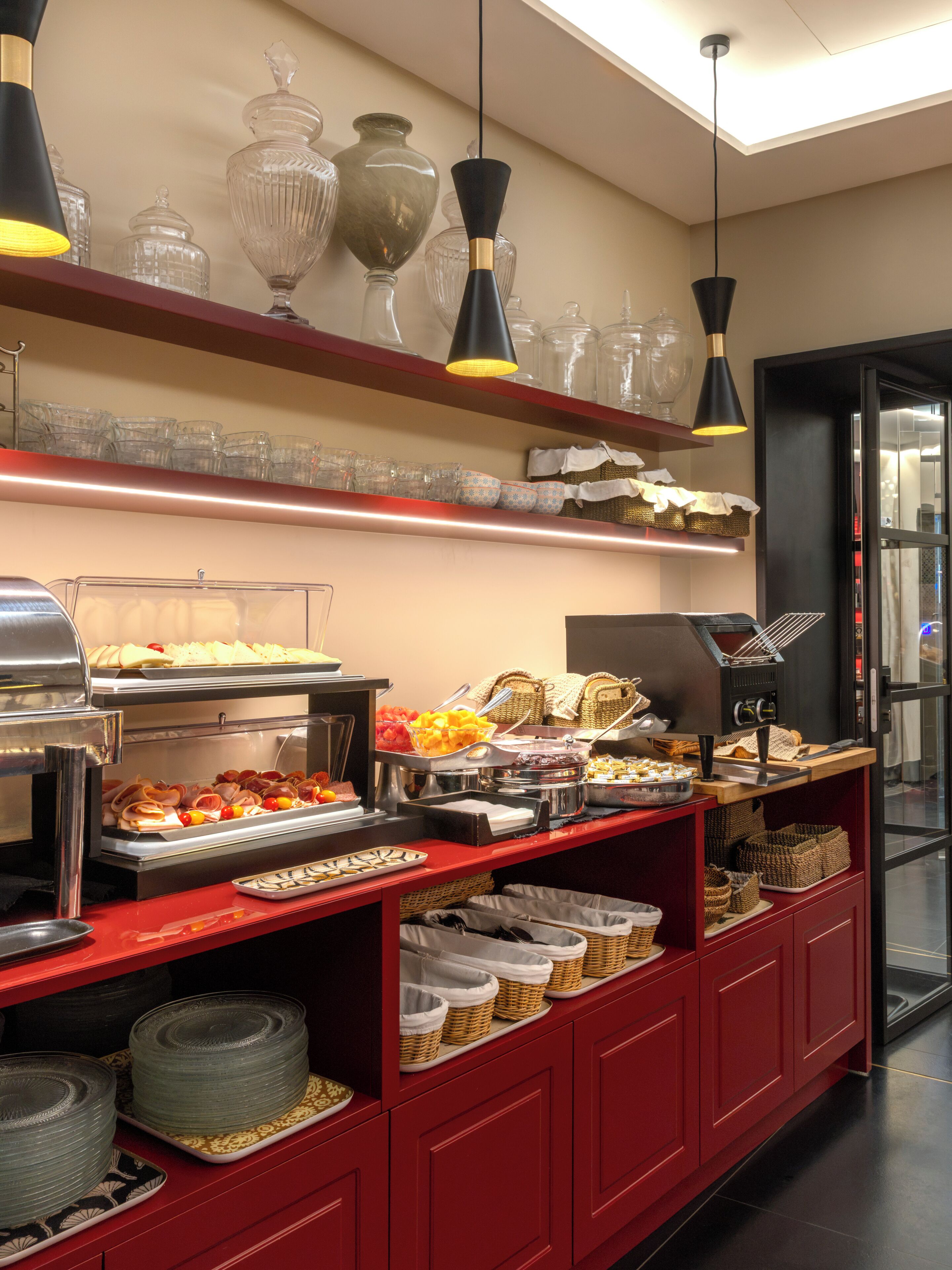 A buffet setup with various food items and glassware on display.