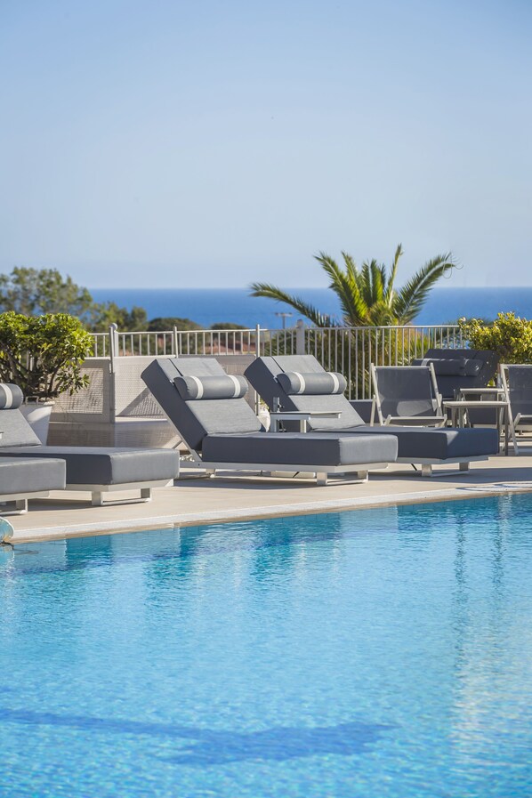 Outdoor pool, open 10:00 AM to 8:00 PM, pool umbrellas, pool loungers