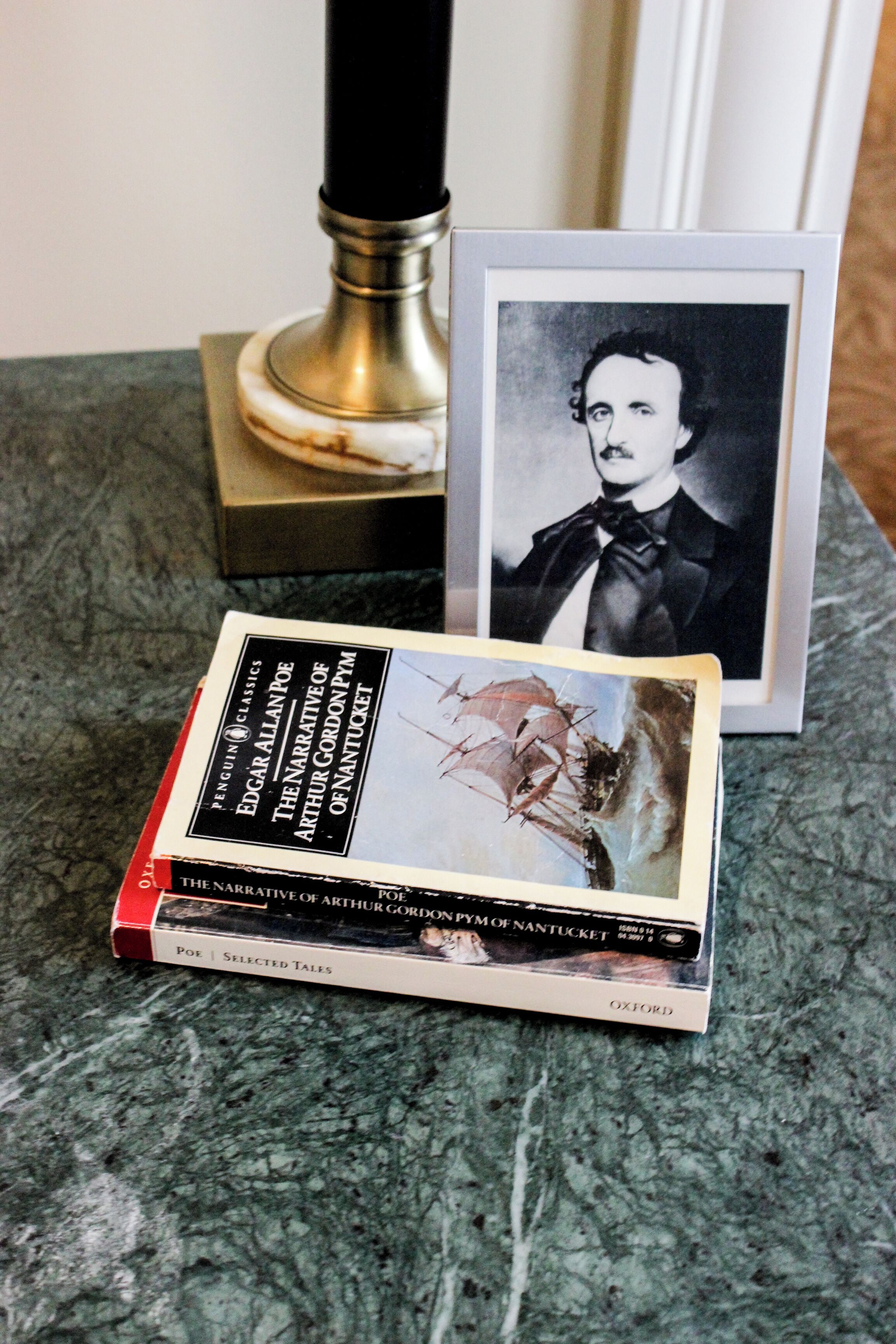 A book titled 'The Narrative of Arthur Gordon Pym of Nantucket' by Edgar Allan Poe, placed on a marble surface.