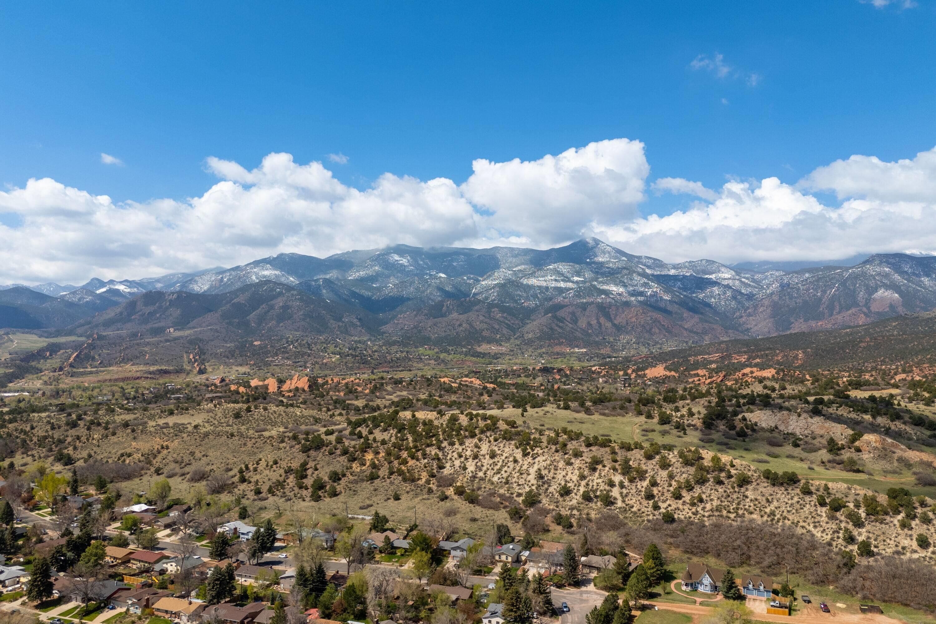 A mountainous landscape with a town in the foreground.