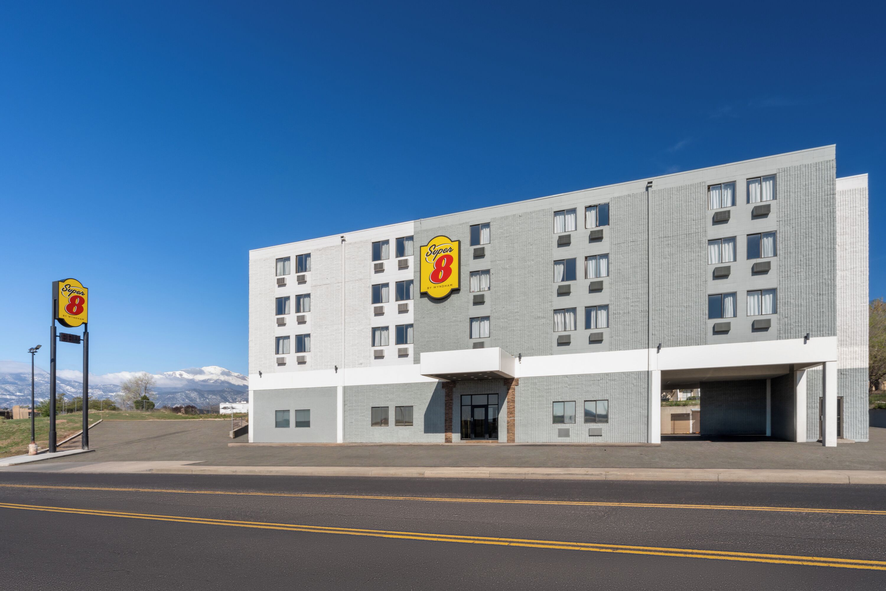 A Super 8 hotel with a modern design, multiple floors, and a parking garage.