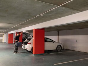 A person opening a car's trunk in a parking garage. - ibis Lyon Caluire Cité Internationale (Caluire-et-Cuire)