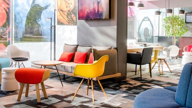 Un'area lounge moderna con divano, poltrone e tavolo da pranzo.