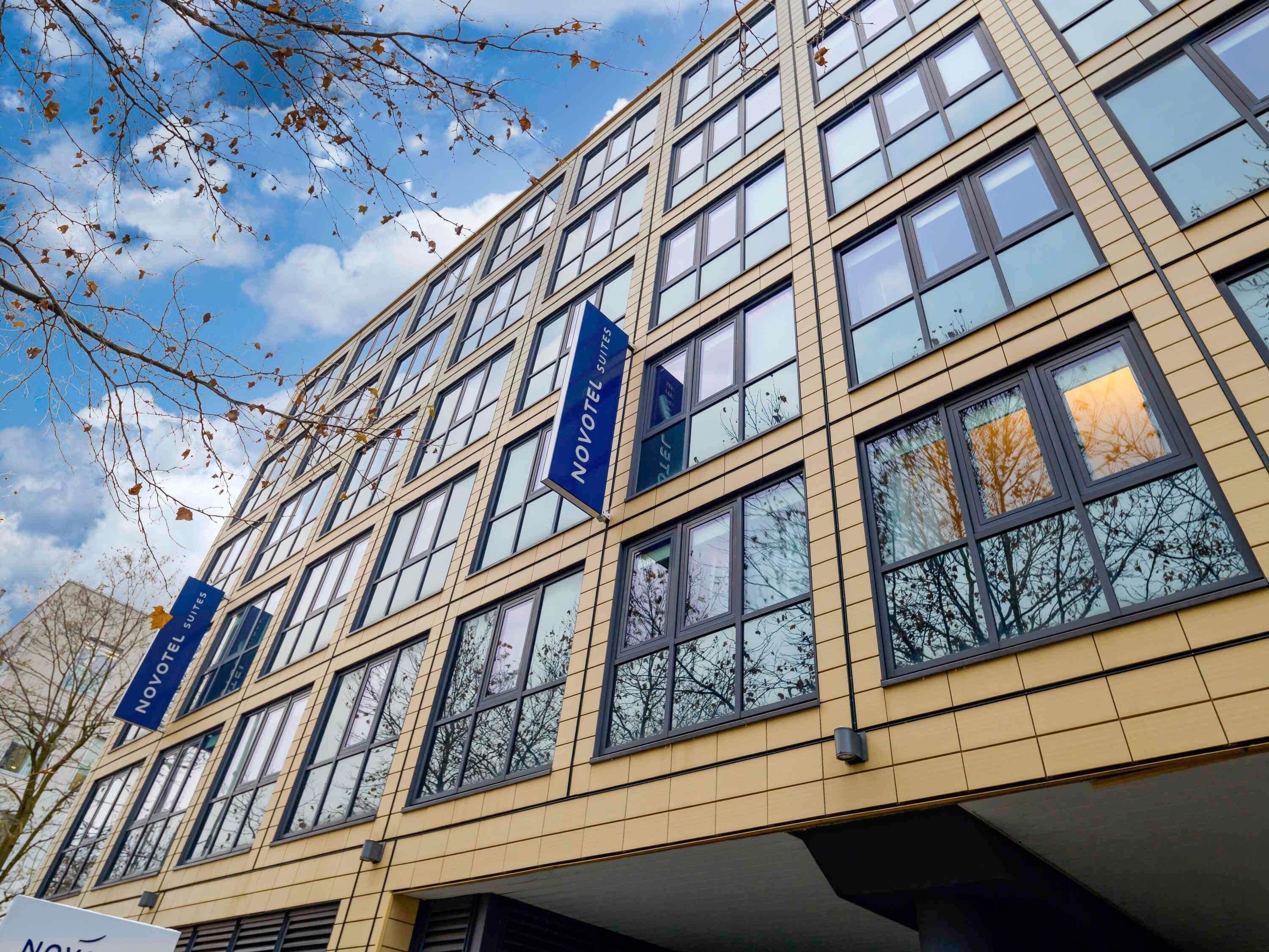A multi-story hotel with a modern architectural design, featuring numerous windows and balconies.