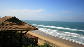 A beachside wooden structure with a tiled roof overlooking the ocean. - Imvubu Lodge (Richards Bay)