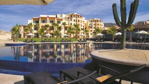 A hotel with a pool, palm trees, and a desert landscape. - Pueblo Bonito Pacifica Golf & Spa Resort -All Inclusive-Adult Only (Cabo San Lucas)