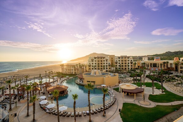 A resort with a central pool, palm trees, and a beach view. - Pueblo Bonito Pacifica Golf & Spa Resort -All Inclusive-Adult Only (Cabo San Lucas)