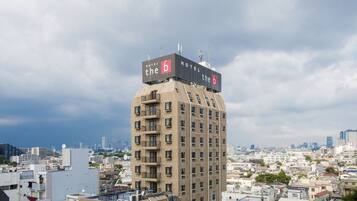 A high-rise hotel with multiple balconies and a prominent 'Hotel b' sign on top.