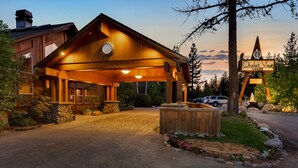 A lodge with a wooden exterior, a covered entrance, and a clock. - Chalet View Lodge (Portola)