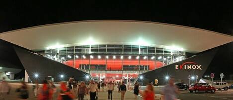 A modern building with a curved roof and the name "EKINOX" on the facade.