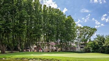 Enjoy a round of golf amidst lush trees and historic buildings.