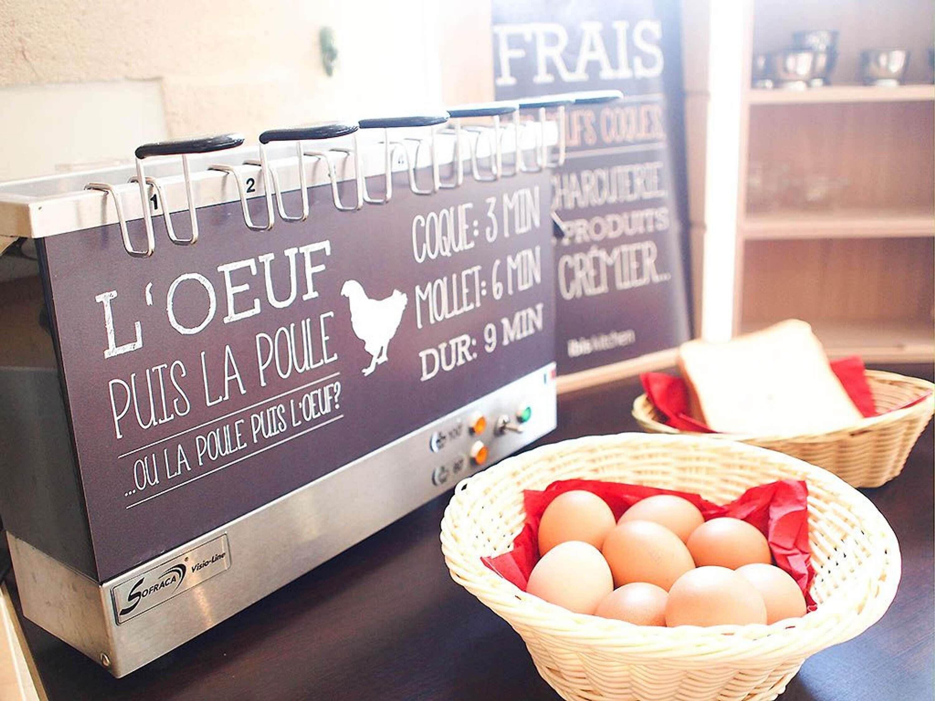 A kitchen counter with a sign indicating cooking times for different meats, a basket of eggs, and a shelf with kitchenware.