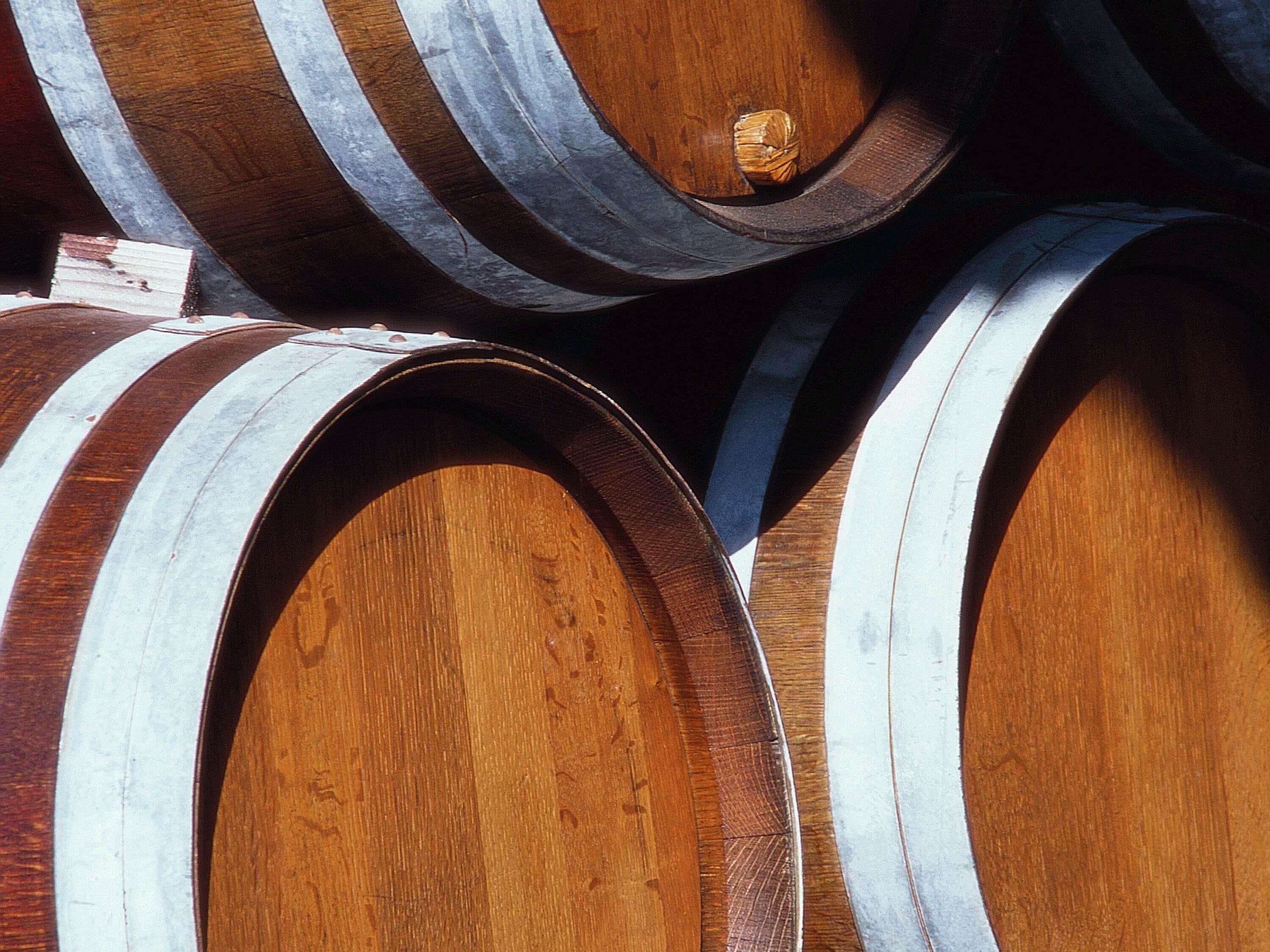 Wooden barrels with metal bands, likely used for aging wine or spirits.