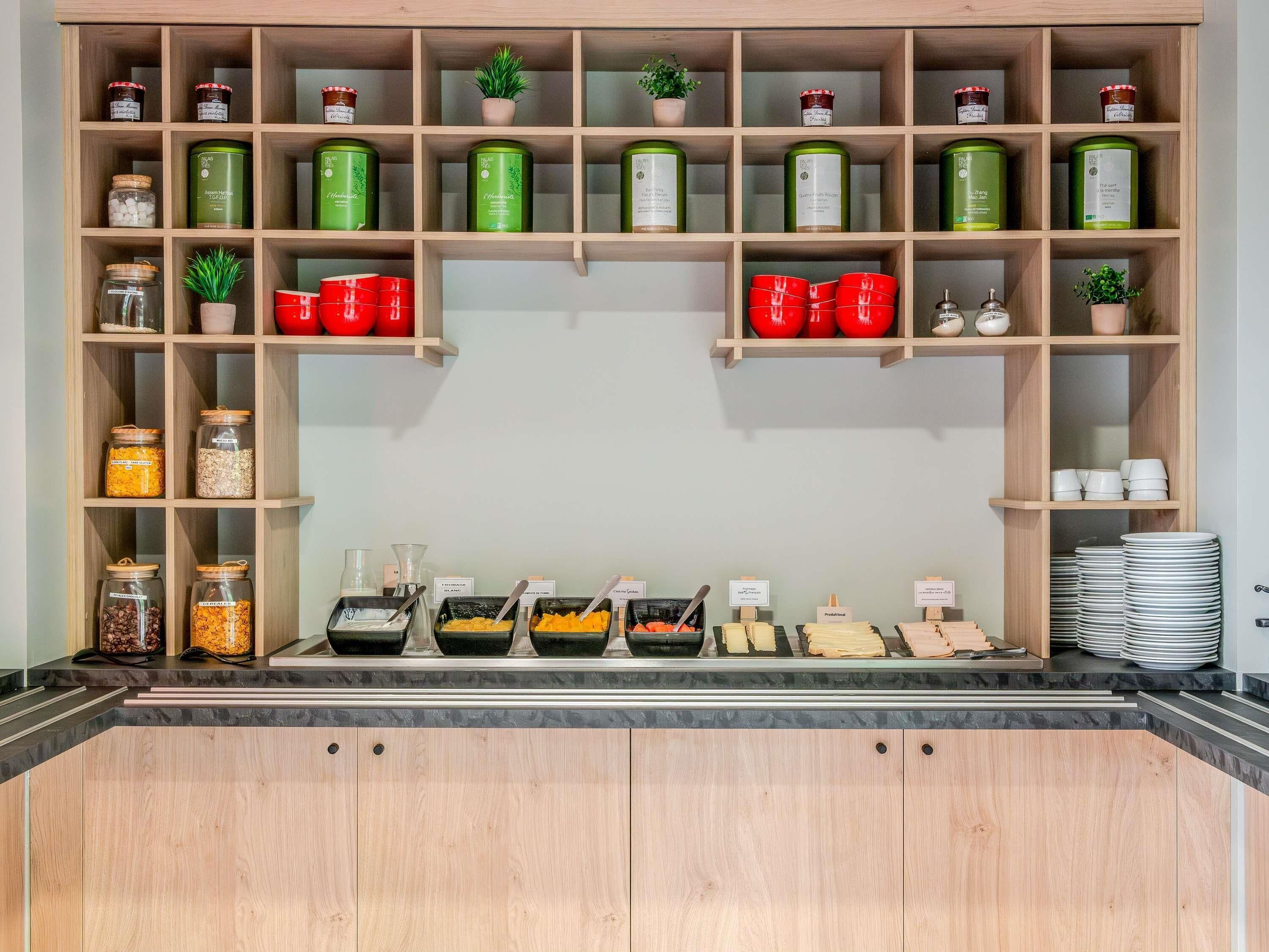 A buffet setup with various food items and condiments.