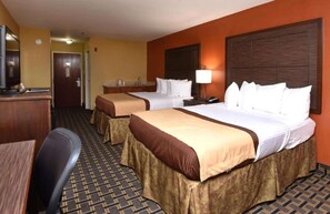 A hotel room with two beds, a desk, a chair, and a television. - Best Western Zachary Inn (Zachary)