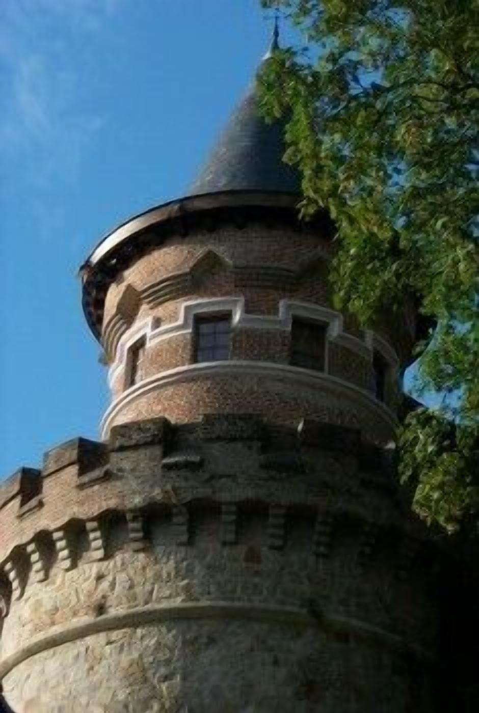 A stone tower with a conical roof, surrounded by greenery.
