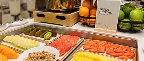 A buffet with various fruits and vegetables.