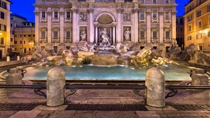A grand architectural structure with a central fountain and statues, surrounded by stone barriers and a paved walkway. - Luxury Rooms H 2000 Roma (Rome)