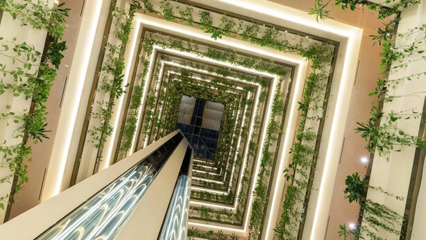 A modern interior with a central spiral staircase surrounded by greenery and illuminated by recessed lighting. - Eurostars Gran Hotel Santiago (Santiago de Compostela)