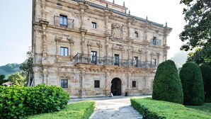 A historic building with a symmetrical facade, multiple windows, and a central entrance.