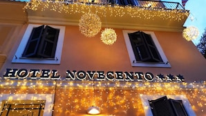 The exterior of Hotel Novecento with decorative lights and a sign. - Hotel Novecento (Rome)