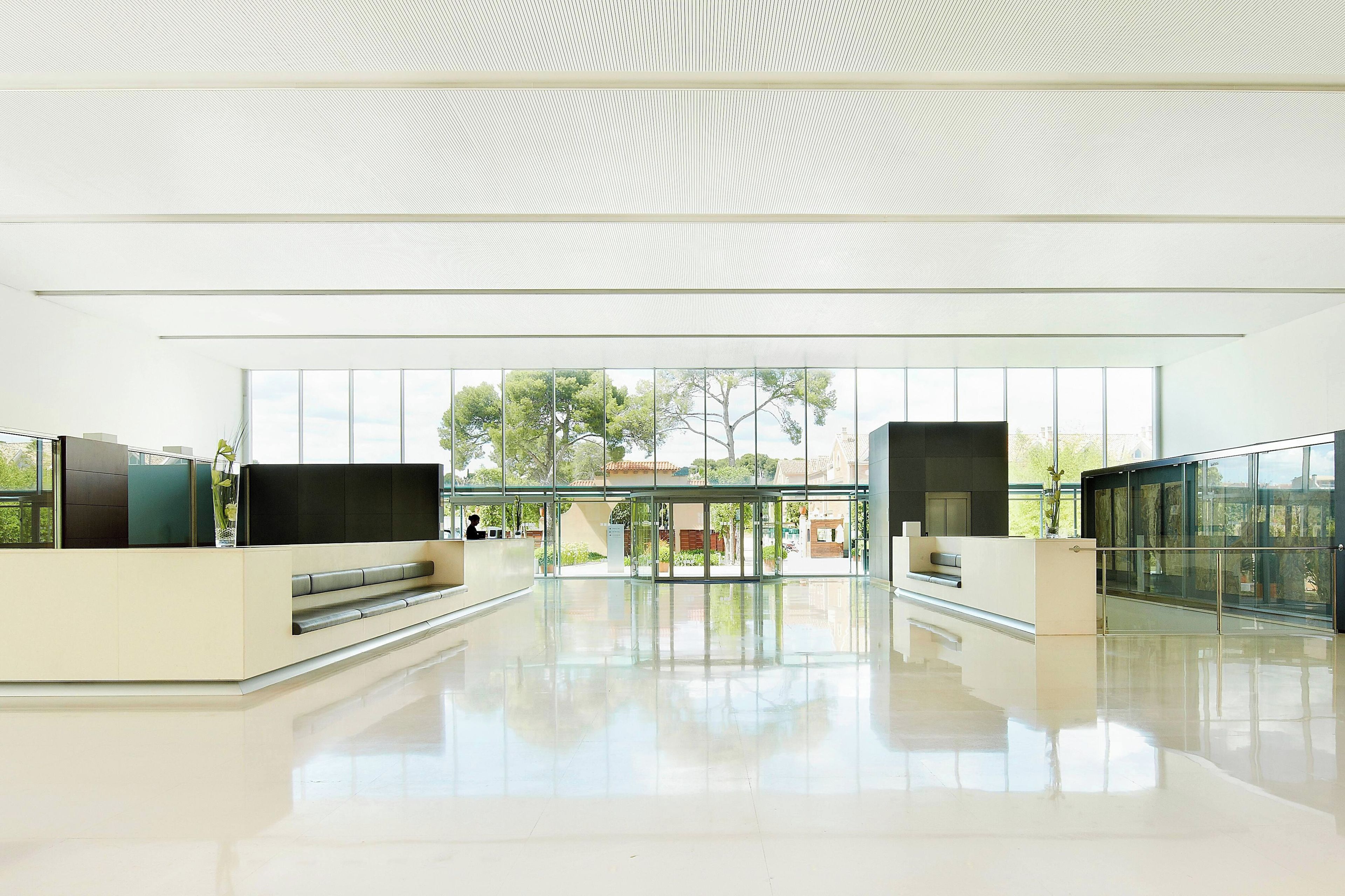 A spacious lobby with a modern design, large windows, and a clear view of the outdoors.