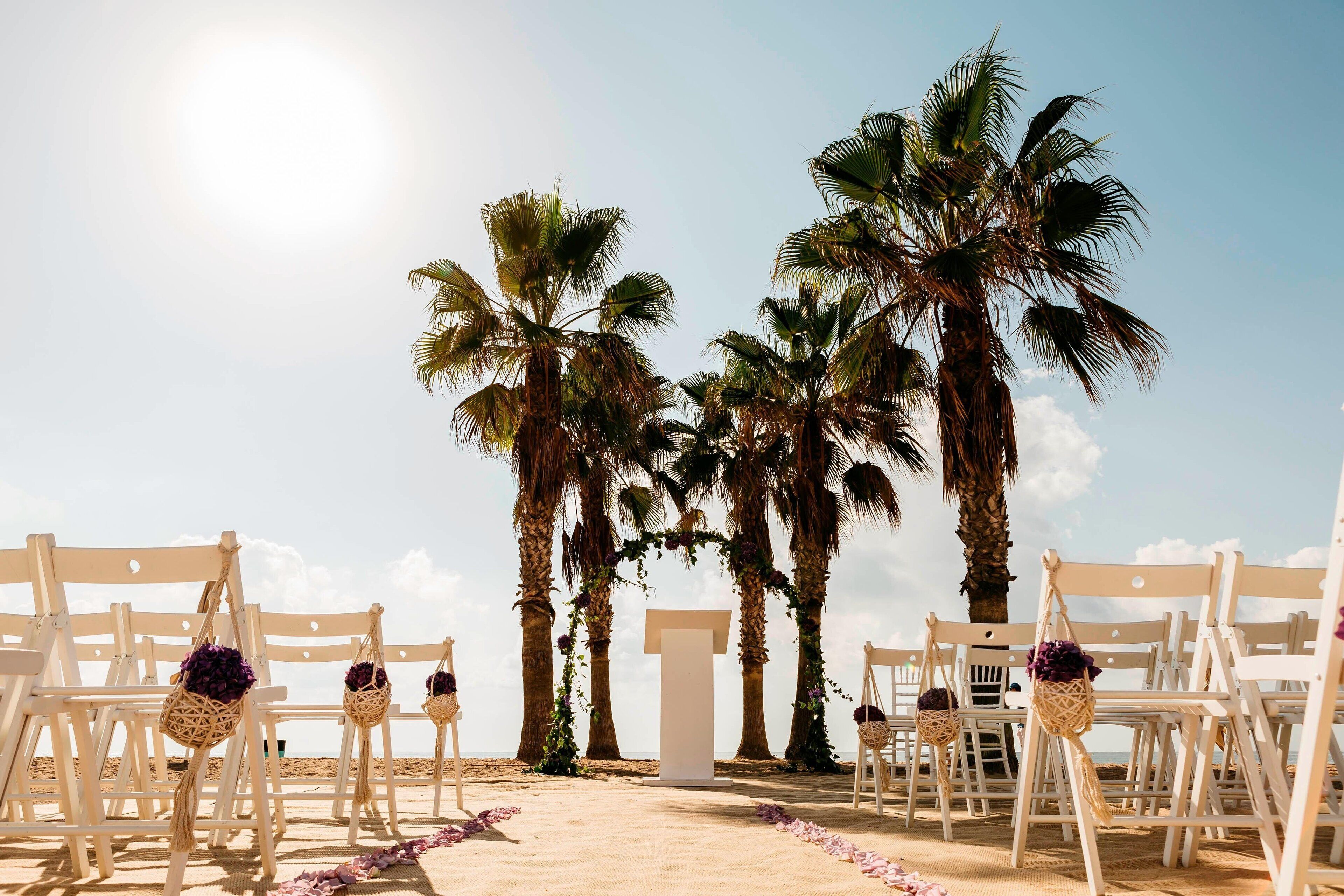on the beach, white sand, beach umbrellas, beach towels
