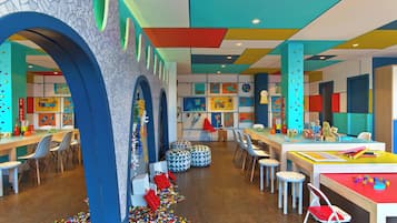 A brightly colored children's play area with tables, chairs, and colorful decorations.