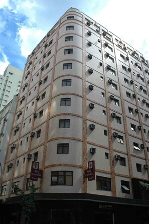 A multi-story hotel with a curved facade, air conditioning units, and signage indicating it is a Real Castillo Hotel. - Real Castilha Hotel (São Paulo)