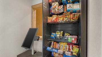 A self-service kiosk with snacks and beverages.