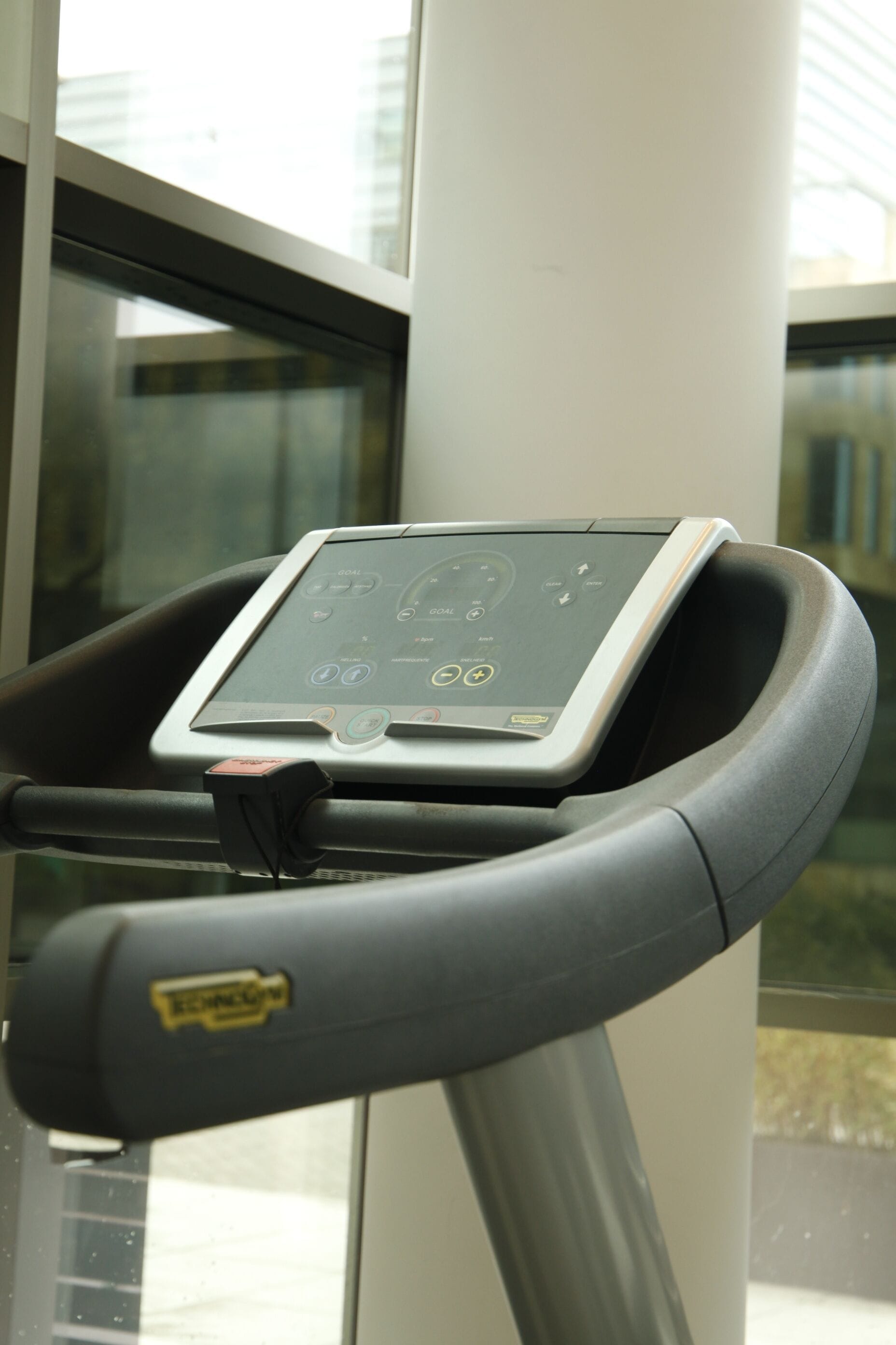 A stationary bike with a digital display, handlebars, and a control panel.