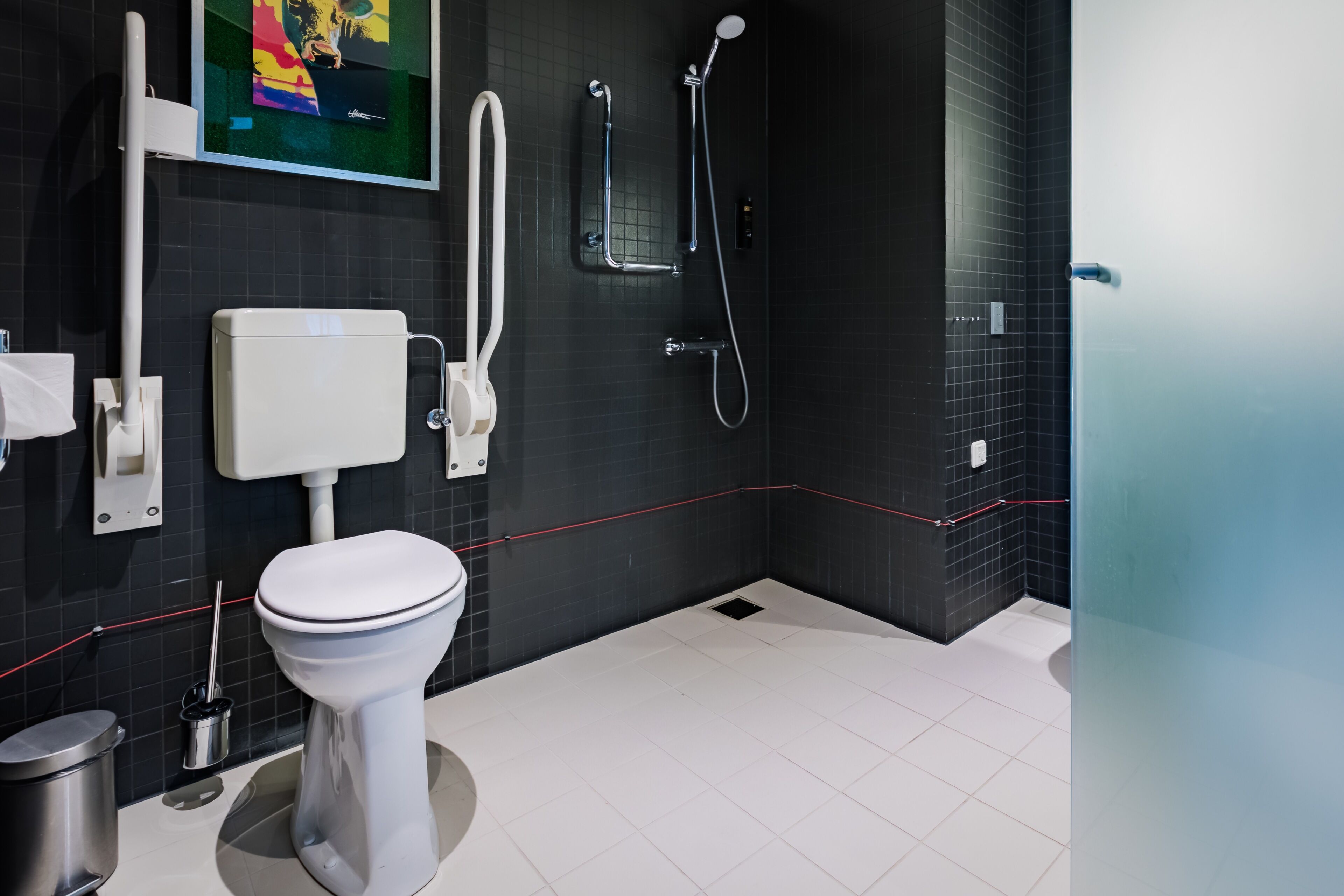 A modern bathroom with a toilet, bidet, and shower.