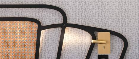 A room with a patterned floor, a black cable management system, and a power outlet.