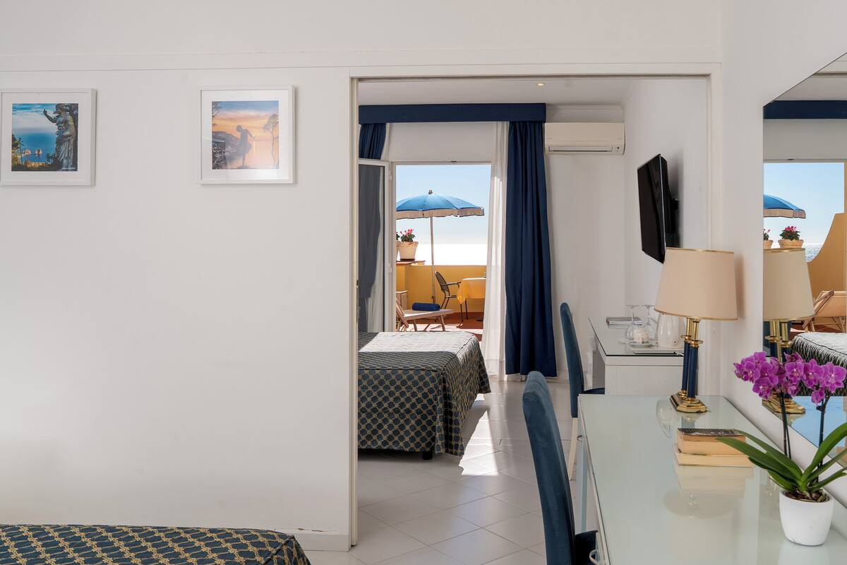 Deluxe Quadruple Room, Balcony | Hypo-allergenic bedding available, minibar, in-room safe, desk