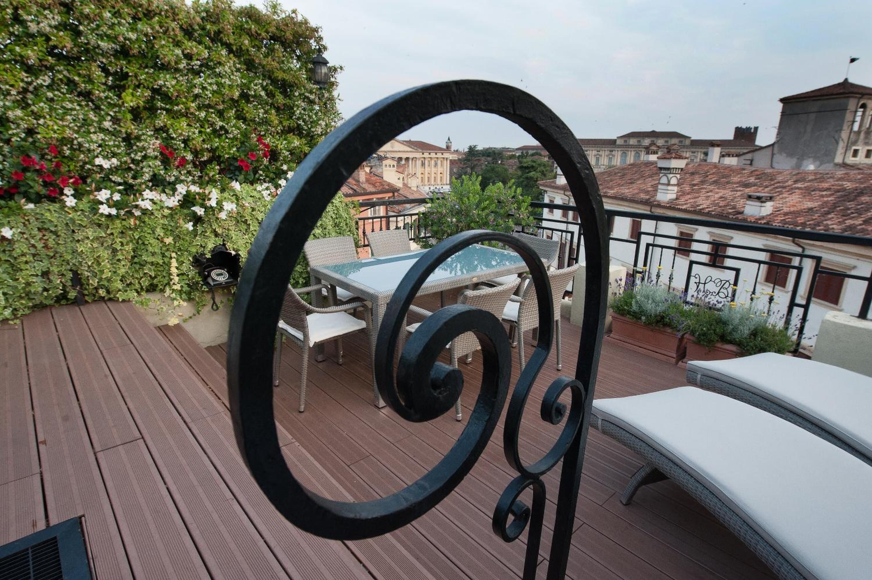 Una terraza en la azotea con mesa de billar, mobiliario de exterior y vistas a edificios.