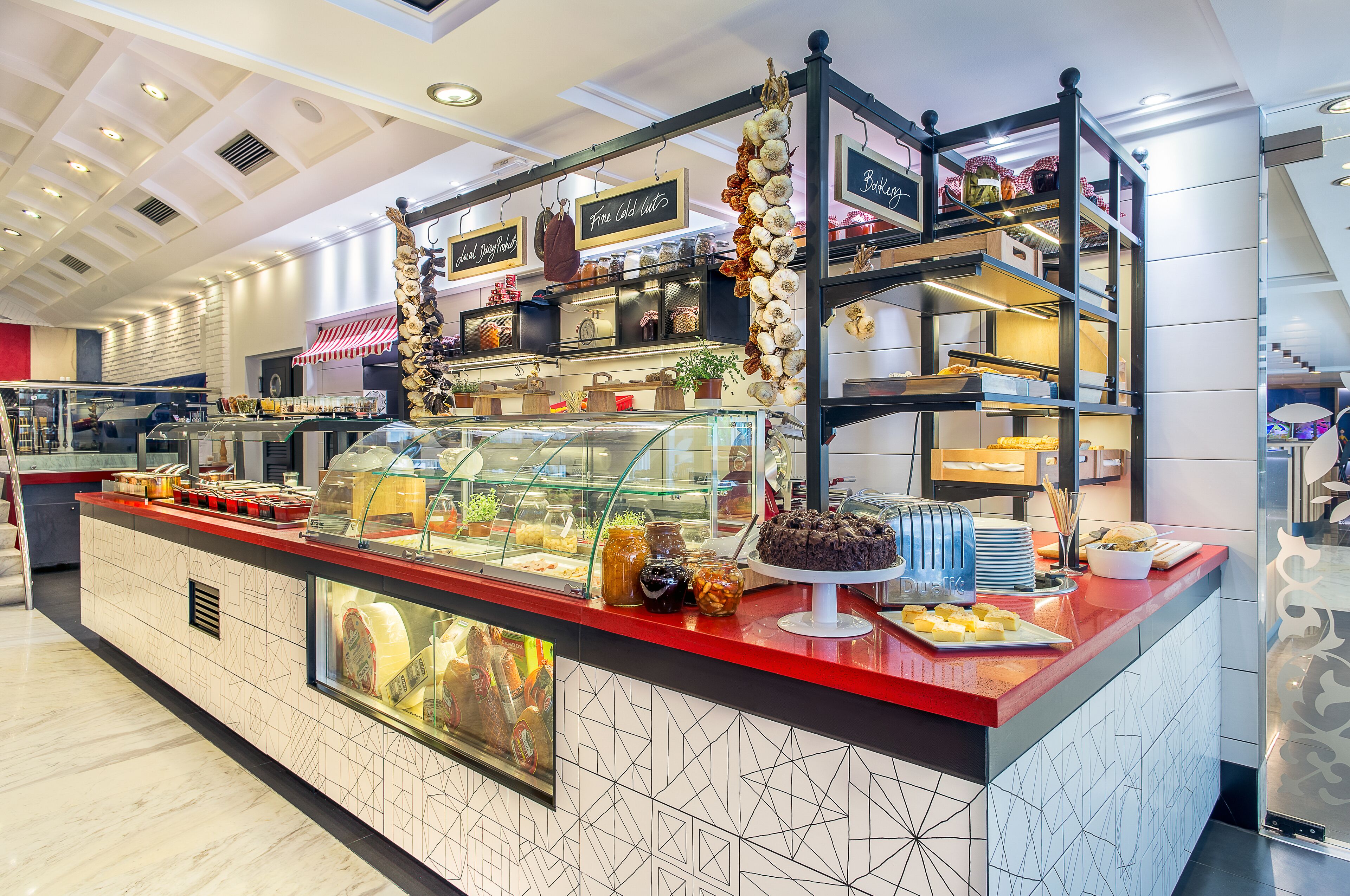 A bakery counter with various baked goods and pastries displayed in glass cases.