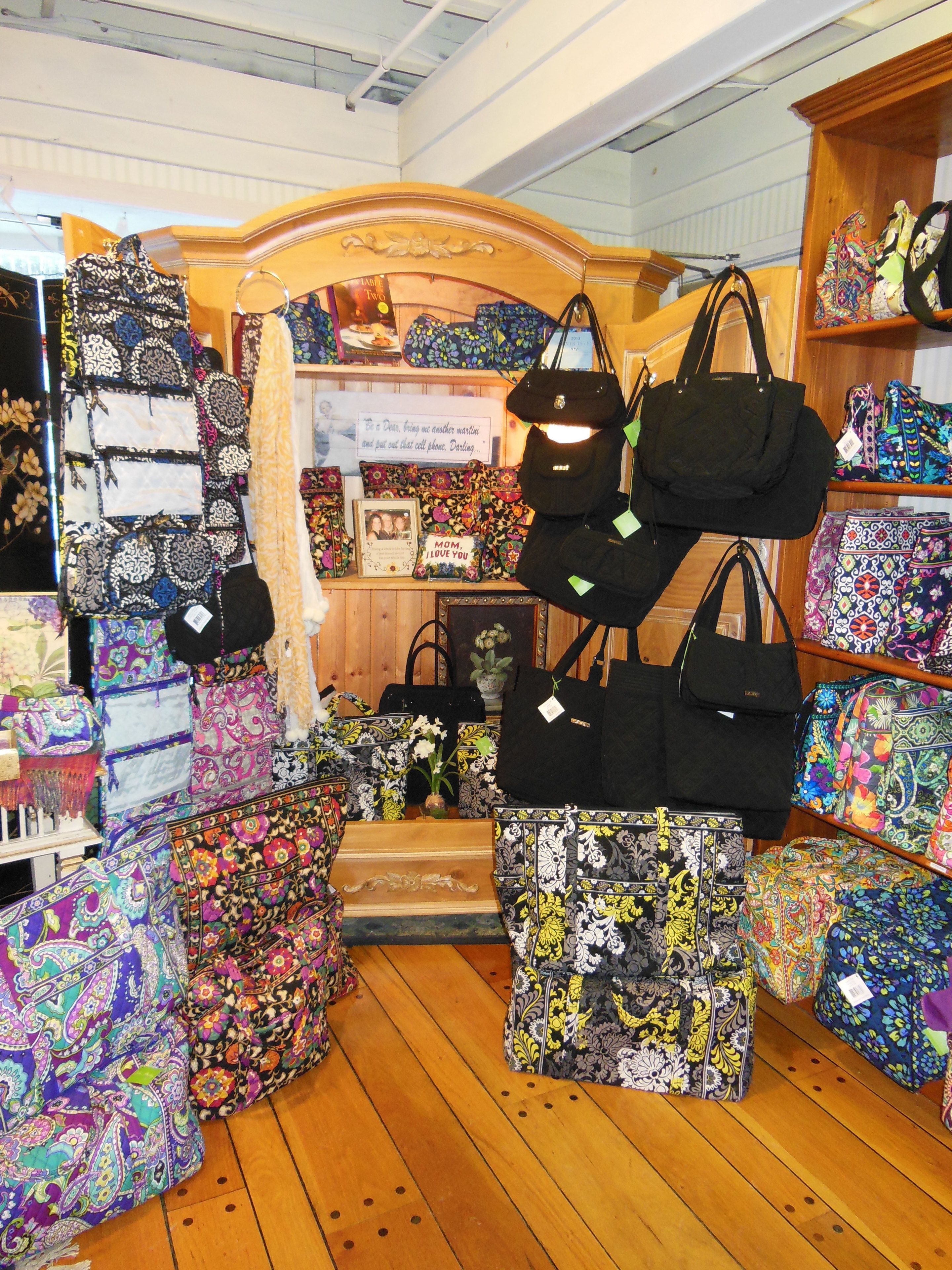A store with various bags displayed on shelves and stands.