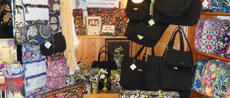 A store with various bags displayed on shelves and stands.