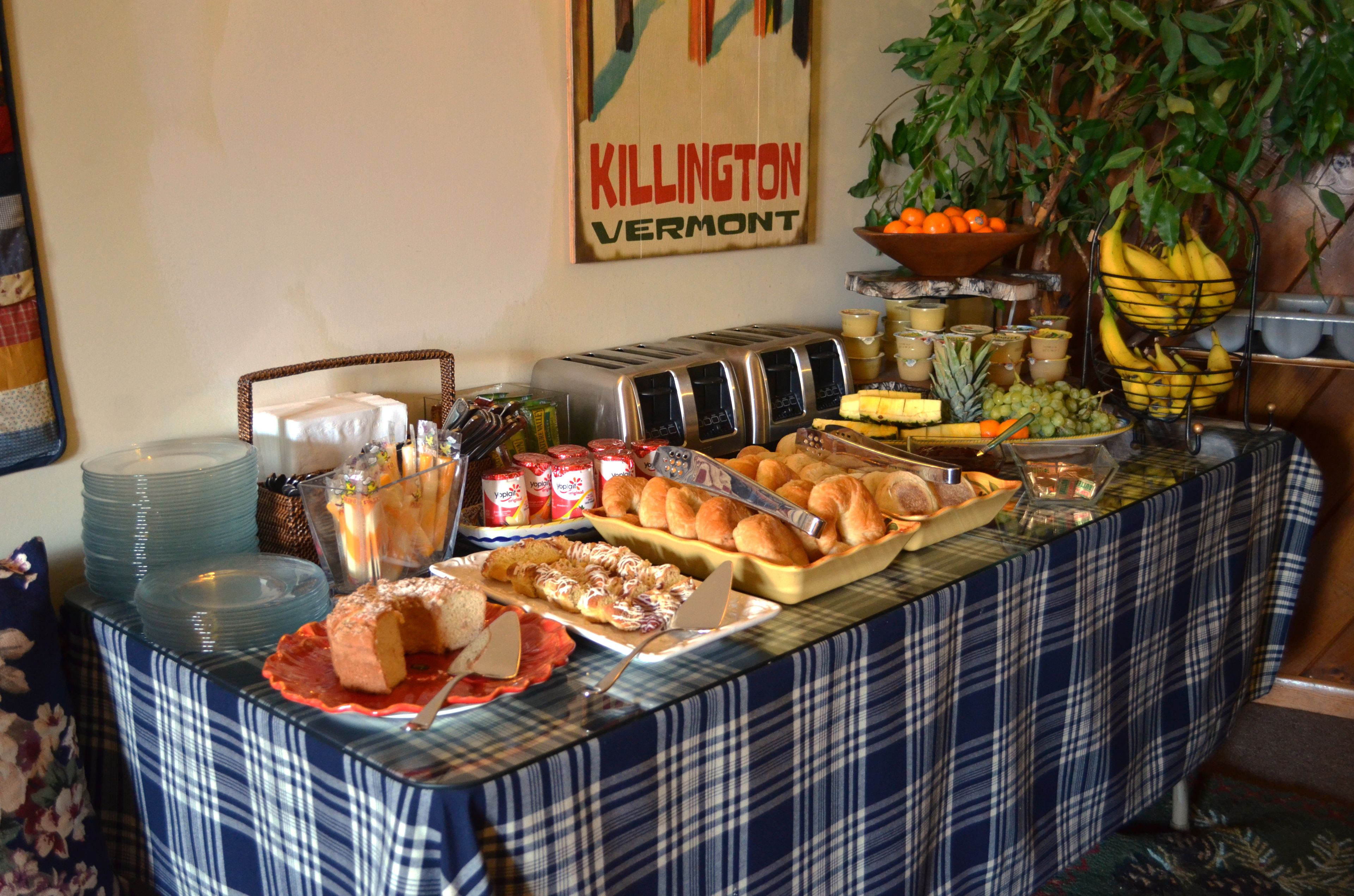 A buffet table with various food items and a sign reading "KILLINGTON VERMONT".