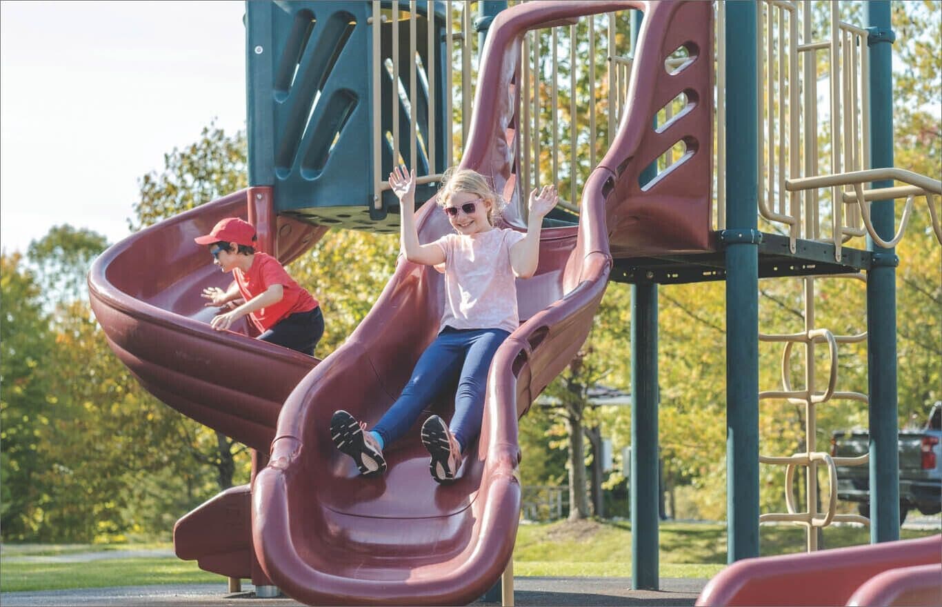 A playground with a slide and climbing structures.