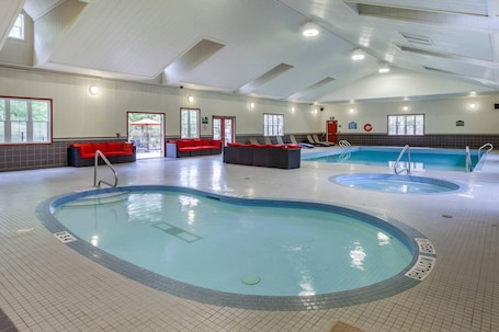 Indoor pool, open 9:00 AM to 10:00 PM, pool umbrellas, sun loungers. Carriage Ridge Resort, an Ascend Collection Resort