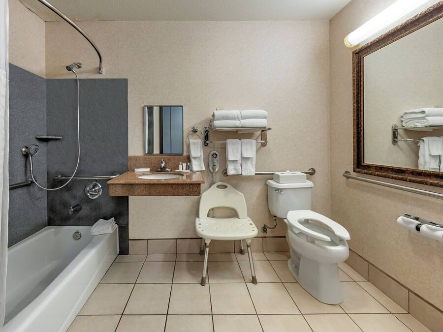 A bathroom with a bathtub, toilet, and shower.