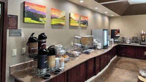 A hotel pantry with a sign indicating it's for employees only. There are coffee and tea dispensers, a refrigerator, and a fruit display. - Citrus Suites Redlands Loma Linda Hotel (Redlands)